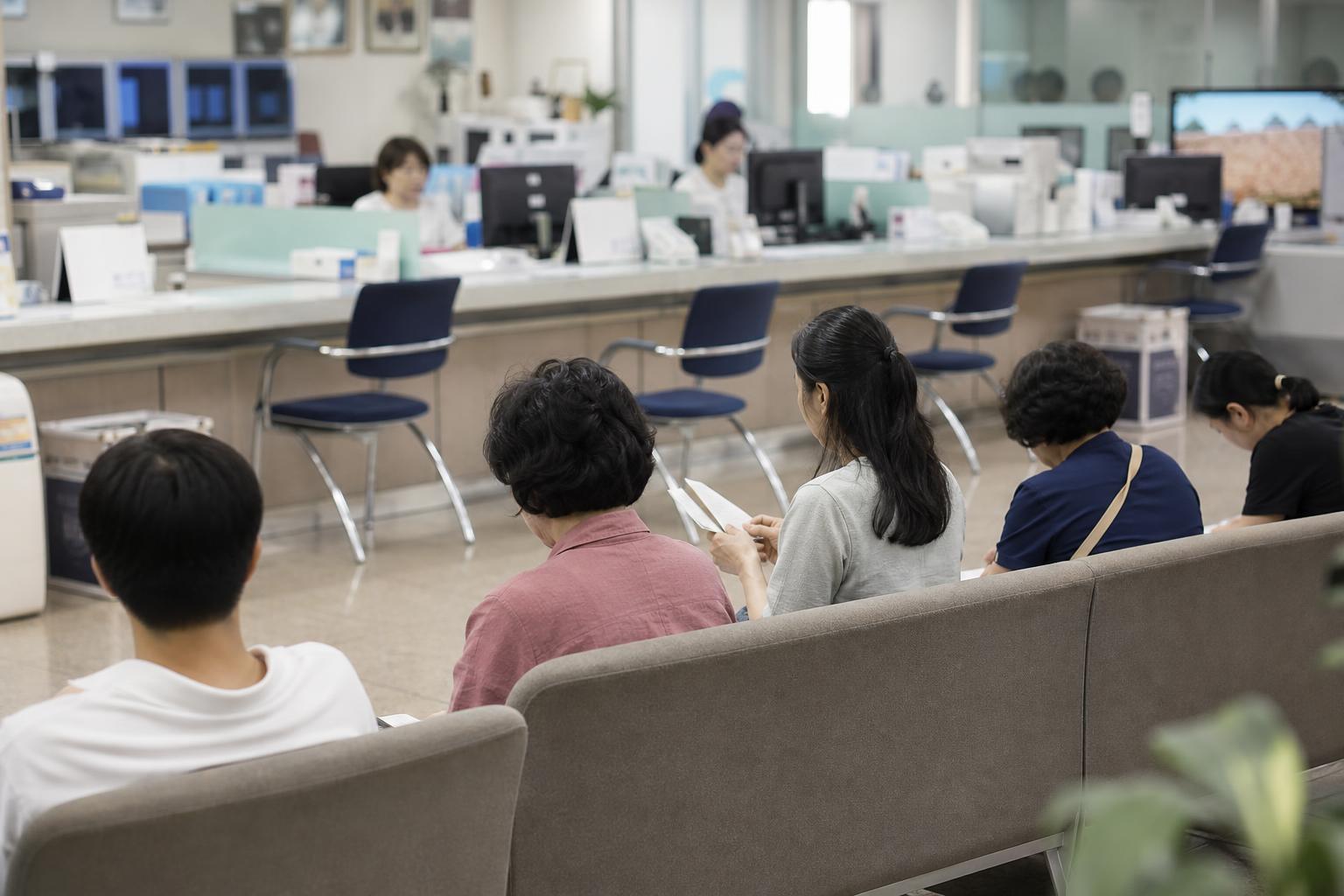 한국의 구청 민원실 창구 앞에서 여러 사람이 순서를 기다리는 모습